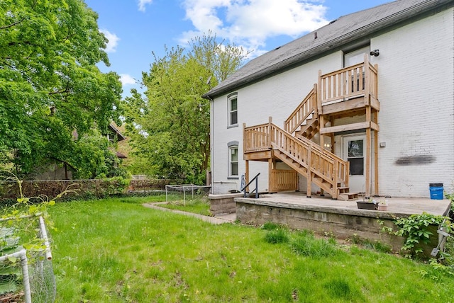612 E 3rd St, Flint, MI 48503 - back of house featuring stairs and brick siding