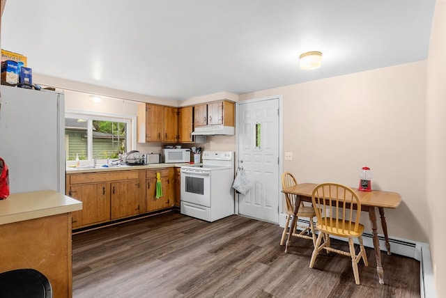612 E 3rd St, Flint, MI 48503 - kitchen featuring white appliances, under cabinet range hood, light countertops, dark wood finished floors, and brown cabinetry