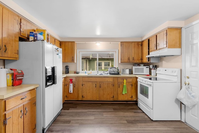 612 E 3rd St, Flint, MI 48503 - kitchen with white appliances, under cabinet range hood, light countertops, a sink, and dark wood-type flooring