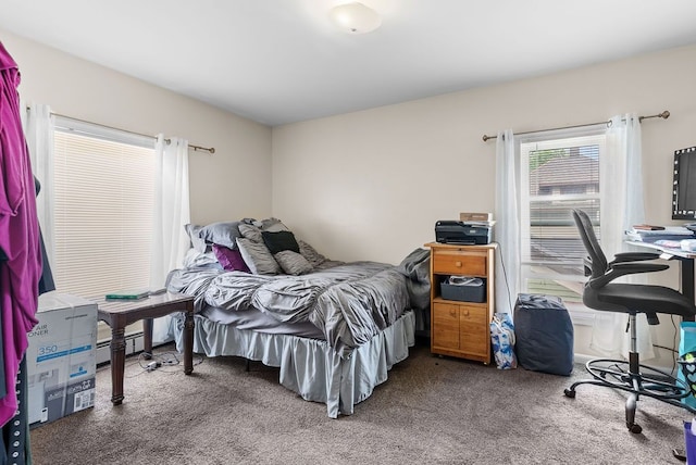 612 E 3rd St, Flint, MI 48503 - carpeted bedroom with a baseboard radiator