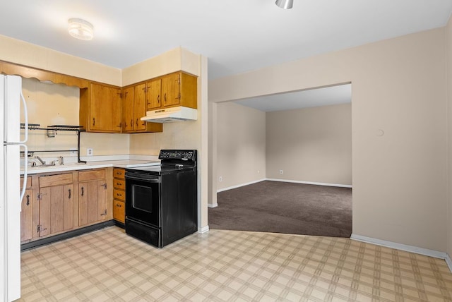 612 E 3rd St, Flint, MI 48503 - kitchen with black electric range oven, under cabinet range hood, light countertops, freestanding refrigerator, and baseboards