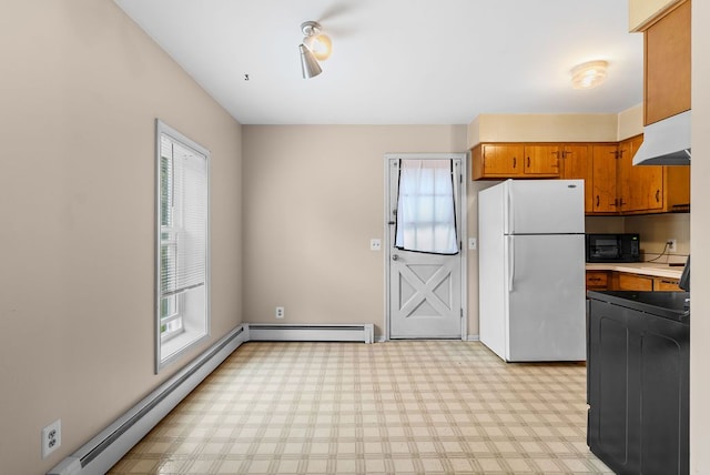 612 E 3rd St, Flint, MI 48503 - kitchen featuring freestanding refrigerator, black microwave, under cabinet range hood, and healthy amount of natural light