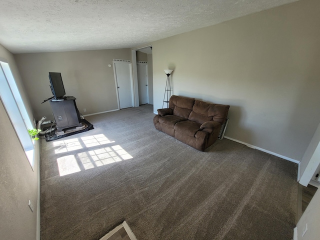 4908 Brookfield Rd, Charlotte, MI 48813 - living area with carpet flooring, a textured ceiling, and baseboards