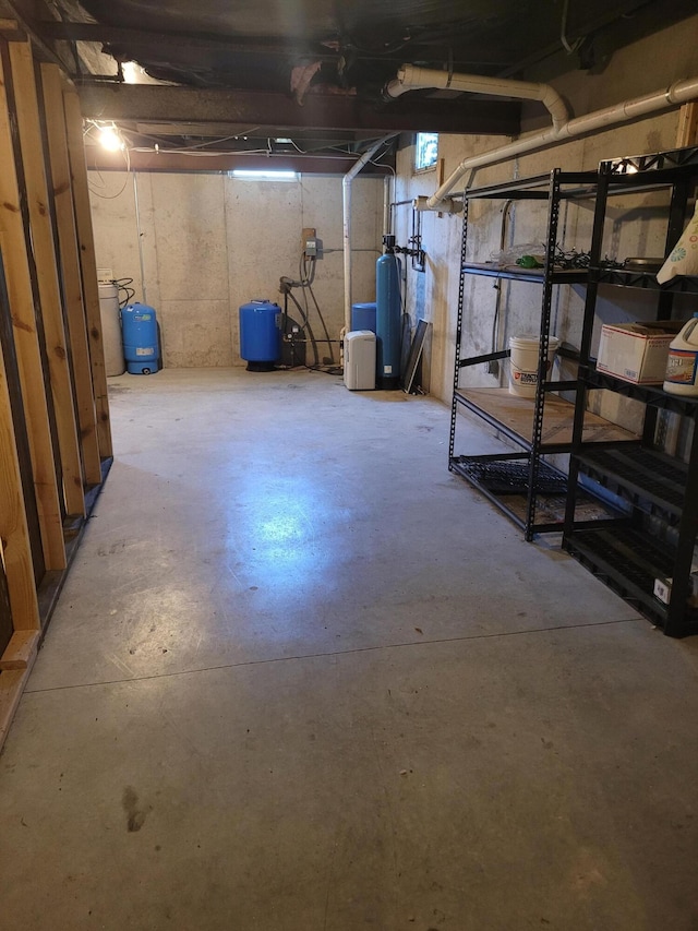 4908 Brookfield Rd, Charlotte, MI 48813 - unfinished basement featuring a water pressure tank and a water softener system