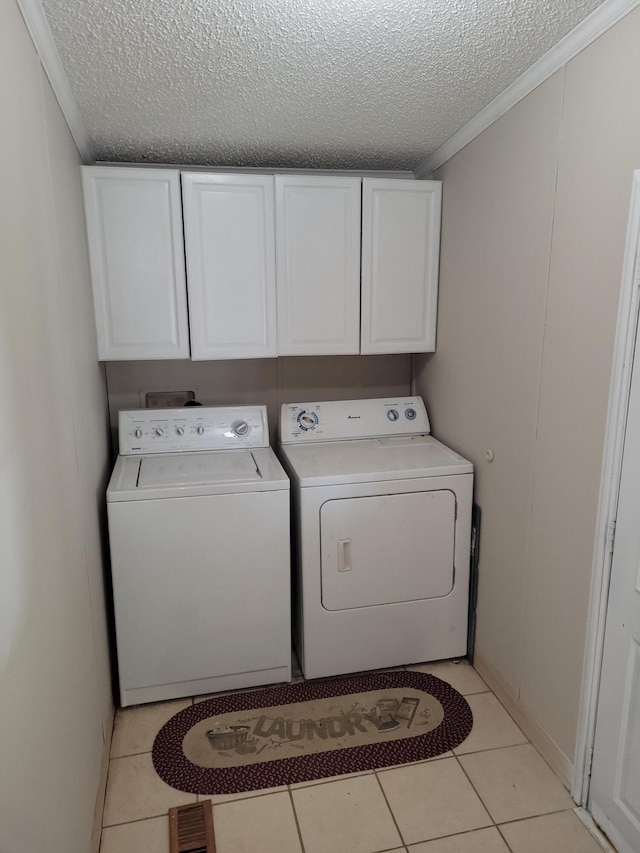 4908 Brookfield Rd, Charlotte, MI 48813 - laundry room with cabinet space, a textured ceiling, separate washer and dryer, light tile patterned flooring, and crown molding
