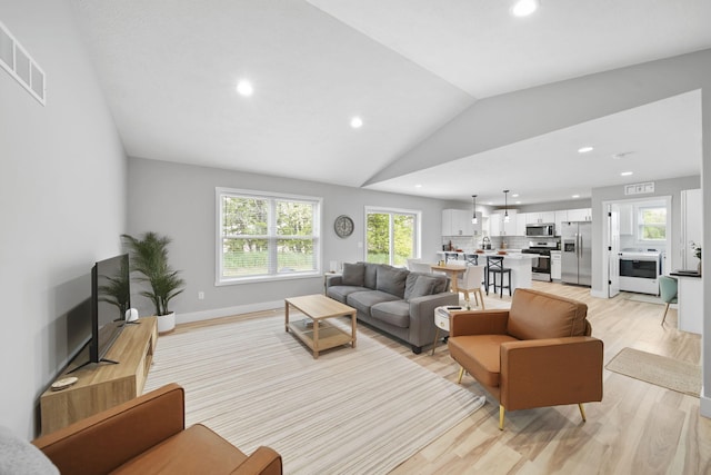 5726 Joshua Dr, Eaton Rapids, MI 48827 - living room featuring light wood-type flooring, recessed lighting, and lofted ceiling