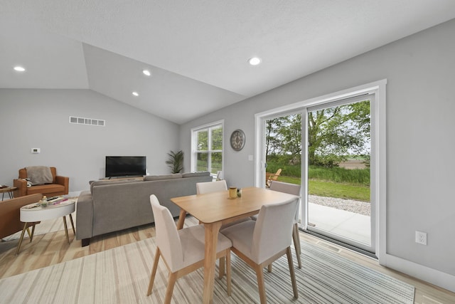 5726 Joshua Dr, Eaton Rapids, MI 48827 - dining area with lofted ceiling, light wood finished floors, and recessed lighting