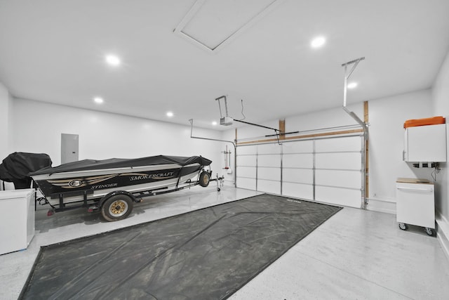 5726 Joshua Dr, Eaton Rapids, MI 48827 - garage featuring a garage door opener, recessed lighting, and electric panel