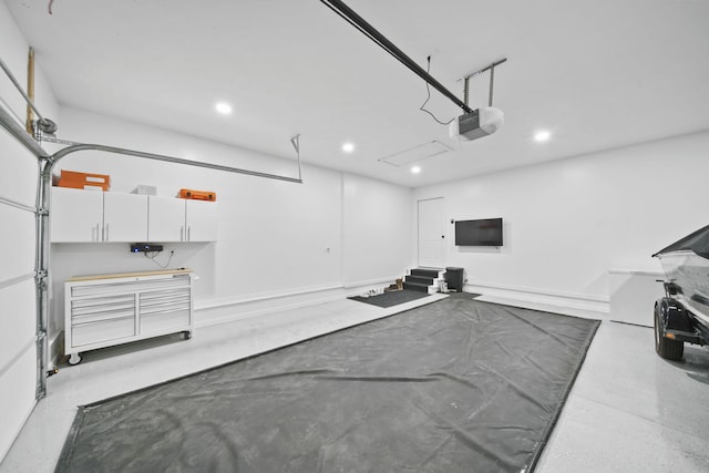 5726 Joshua Dr, Eaton Rapids, MI 48827 - garage with a garage door opener and recessed lighting