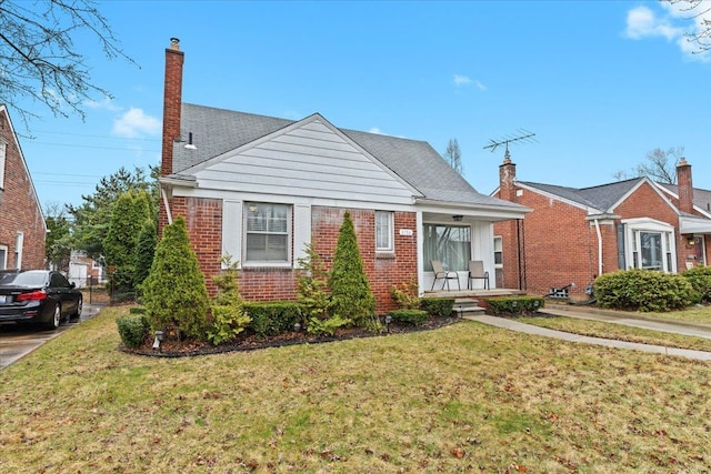 8156 Grayfield St, Dearborn Heights, MI 48127 - bungalow-style house with a porch, a front yard, and brick siding