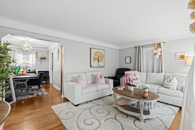 8156 Grayfield St, Dearborn Heights, MI 48127 - living room with a chandelier, wood finished floors, and baseboards