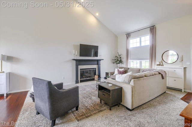 4422 Jordan Dr, Grand Blanc, MI 48439 - living area featuring high vaulted ceiling, wood finished floors, a fireplace with flush hearth, baseboards, and recessed lighting