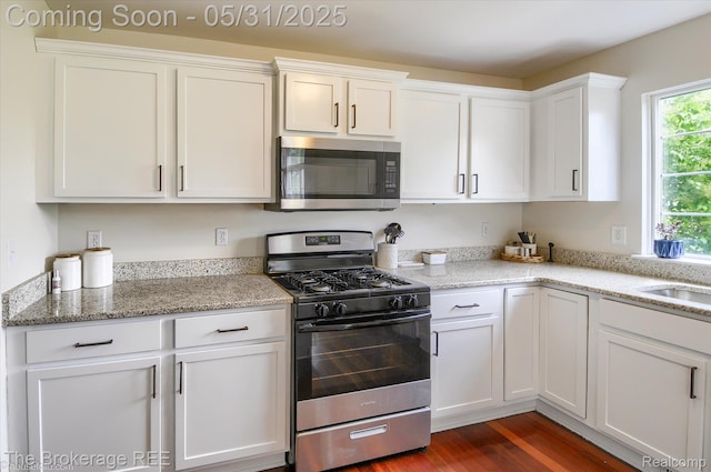 4422 Jordan Dr, Grand Blanc, MI 48439 - kitchen featuring stainless steel appliances, white cabinets, dark wood-style flooring, and light stone counters