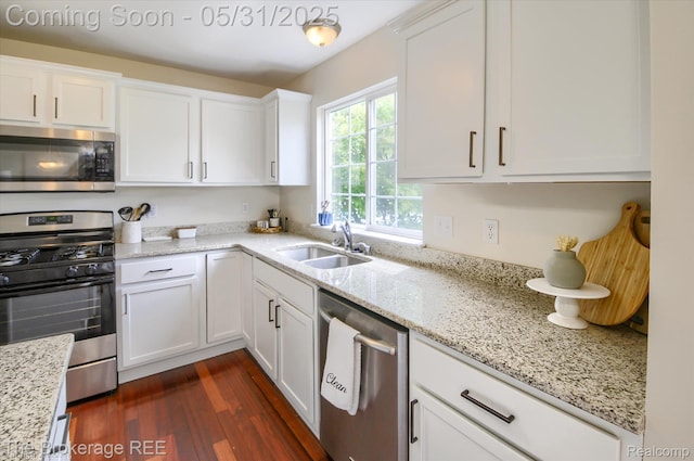 4422 Jordan Dr, Grand Blanc, MI 48439 - kitchen featuring appliances with stainless steel finishes, white cabinets, a sink, dark wood finished floors, and light stone countertops