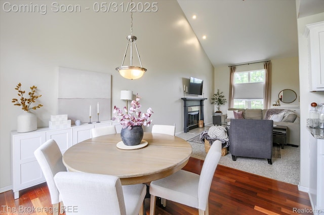 4422 Jordan Dr, Grand Blanc, MI 48439 - dining space with high vaulted ceiling, wood finished floors, recessed lighting, and a fireplace with flush hearth