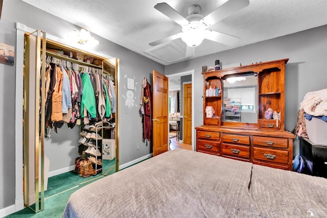 12323 Oakland Ave, Mount Morris, MI 48458 - carpeted bedroom featuring a closet, a textured ceiling, baseboards, and ceiling fan