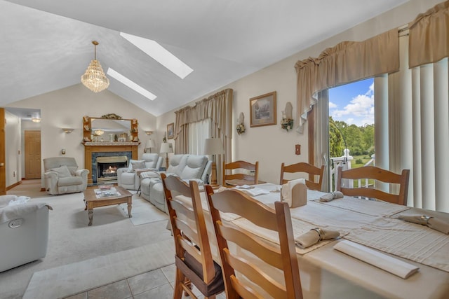 3460 Sears Rd, Horton, MI 49246 - dining area featuring a skylight, light tile patterned floors, lofted ceiling, a lit fireplace, and light carpet