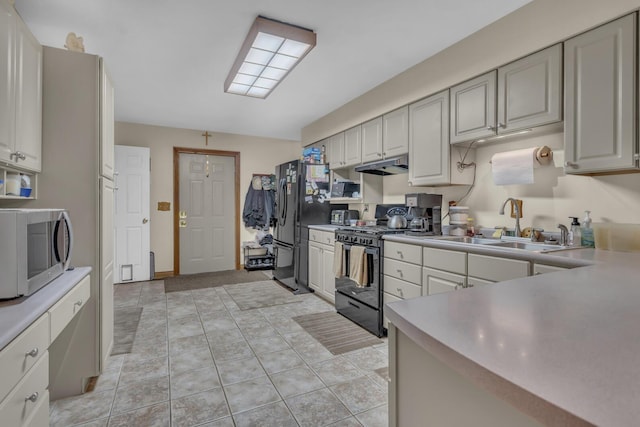 3460 Sears Rd, Horton, MI 49246 - kitchen featuring black appliances, under cabinet range hood, light countertops, and a sink