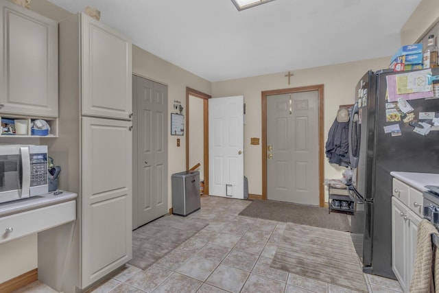3460 Sears Rd, Horton, MI 49246 - kitchen featuring stainless steel appliances, light countertops, white cabinets, and baseboards