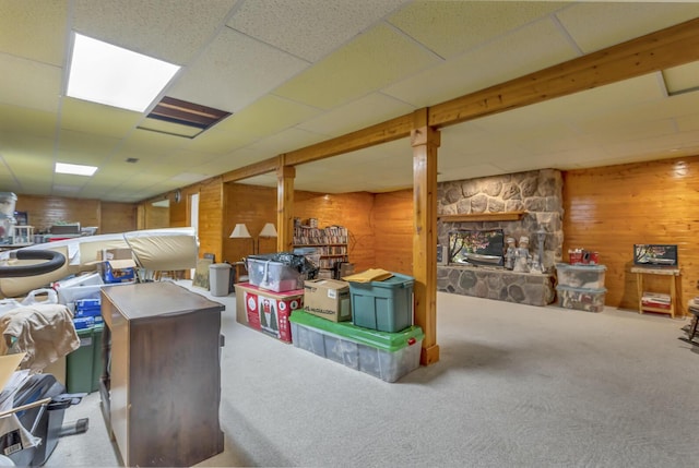 3460 Sears Rd, Horton, MI 49246 - finished basement with wood walls, carpet, and a stone fireplace