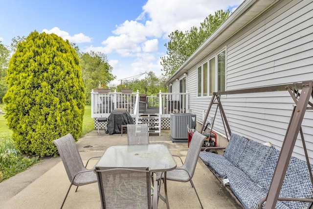 3460 Sears Rd, Horton, MI 49246 - view of patio featuring cooling unit, outdoor dining area, a wooden deck, and area for grilling
