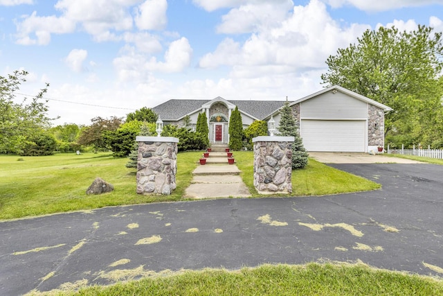 3460 Sears Rd, Horton, MI 49246 - view of front of house featuring asphalt driveway, a garage, and a front yard