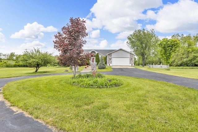 3460 Sears Rd, Horton, MI 49246 - obstructed view of property with driveway, an attached garage, a front lawn, and stone siding
