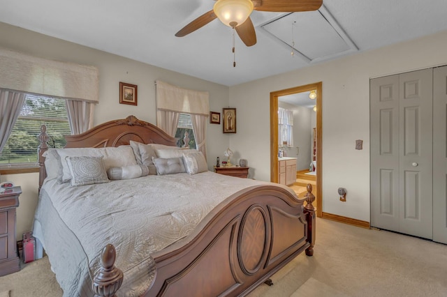 3460 Sears Rd, Horton, MI 49246 - bedroom with attic access, light colored carpet, ensuite bathroom, baseboards, and a ceiling fan