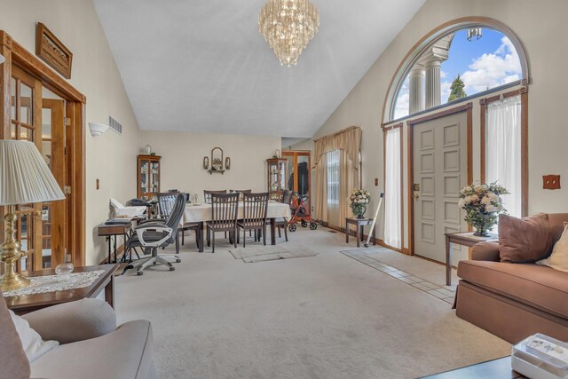 3460 Sears Rd, Horton, MI 49246 - foyer entrance featuring high vaulted ceiling, carpet flooring, a chandelier, and plenty of natural light