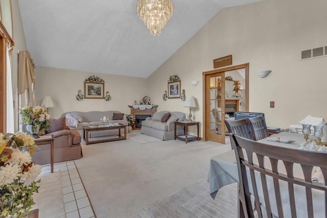 3460 Sears Rd, Horton, MI 49246 - living area featuring a fireplace, a chandelier, light carpet, and high vaulted ceiling
