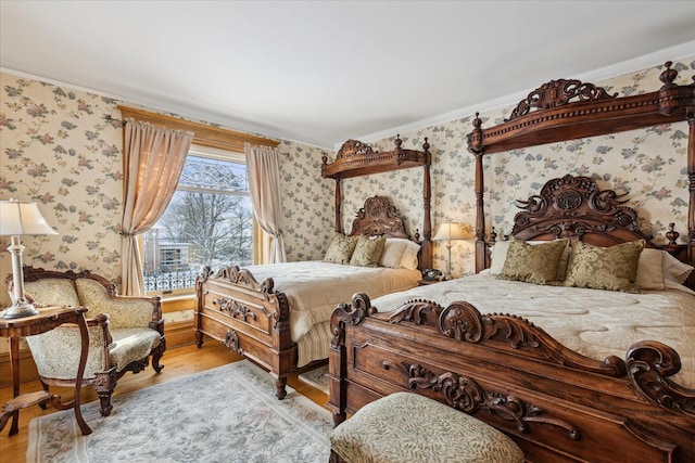 303 S State Ave, Alpena, MI 49707 - bedroom featuring wood finished floors, wallpapered walls, and ornamental molding