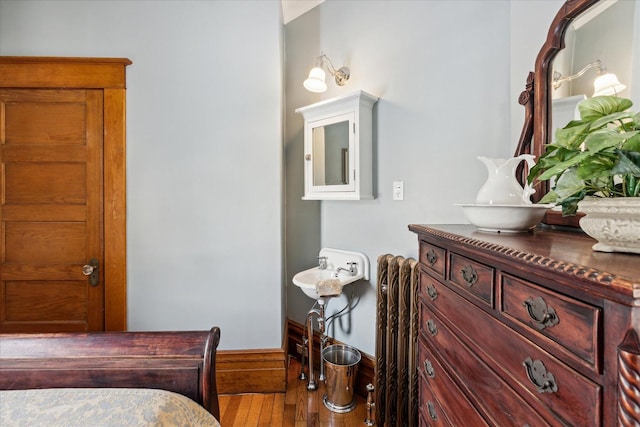 303 S State Ave, Alpena, MI 49707 - bedroom featuring hardwood / wood-style flooring and baseboards