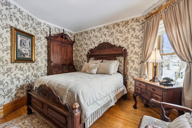 303 S State Ave, Alpena, MI 49707 - bedroom featuring wallpapered walls, light wood finished floors, ornamental molding, and baseboards