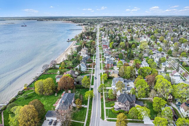 303 S State Ave, Alpena, MI 49707 - aerial overview of property's location with a large body of water and nearby suburban area