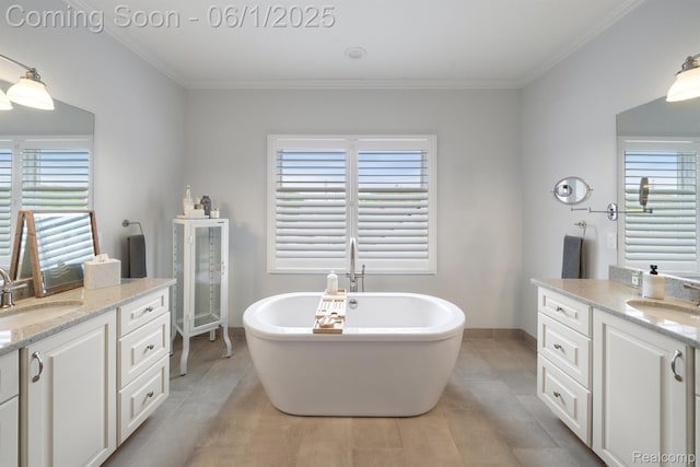 1992 Shipman Blvd, Birmingham, MI 48009 - full bathroom featuring two vanities, a freestanding bath, plenty of natural light, and ornamental molding