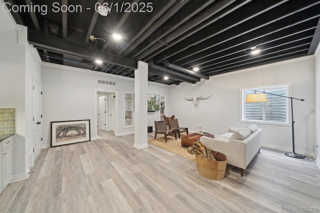 1992 Shipman Blvd, Birmingham, MI 48009 - living area featuring light wood-style floors, baseboards, and decorative columns