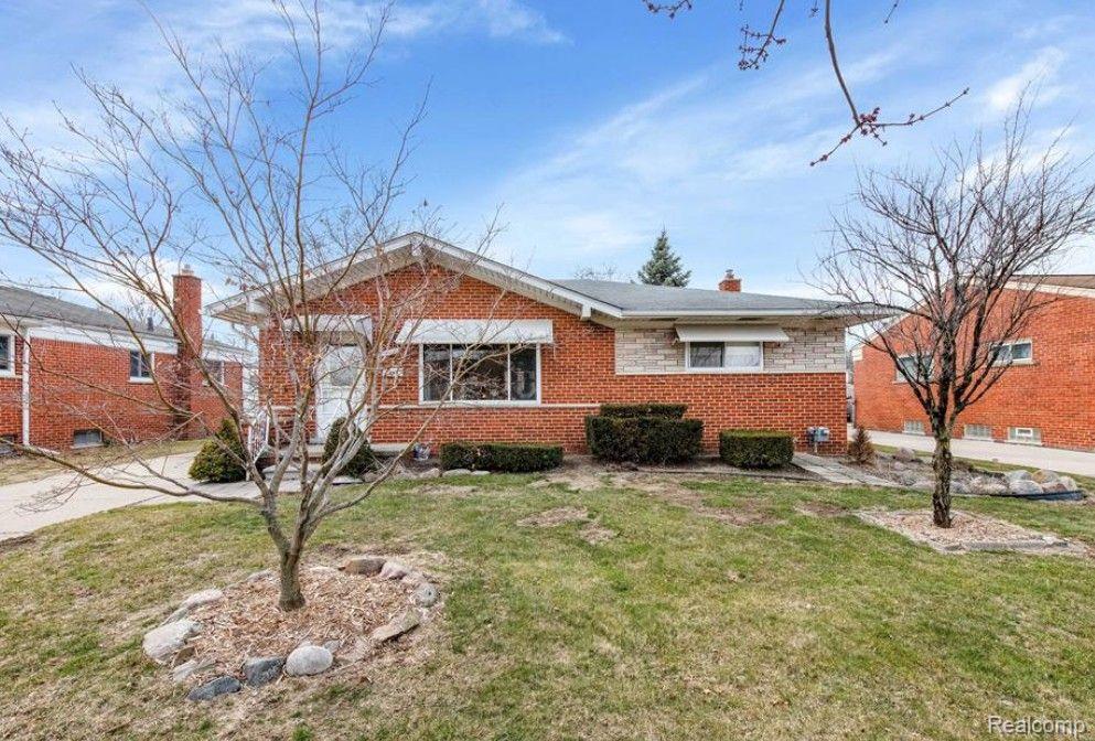 24223 Loretta Ave, Warren, MI 48091 - view of front of home with a front lawn, brick siding, and a chimney