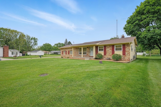 1451 Peachwood Dr, Flint, MI 48507 - single story home with brick siding, a front lawn, a chimney, and a porch