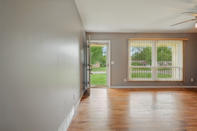 1451 Peachwood Dr, Flint, MI 48507 - unfurnished room with light wood-style floors, a ceiling fan, and baseboards