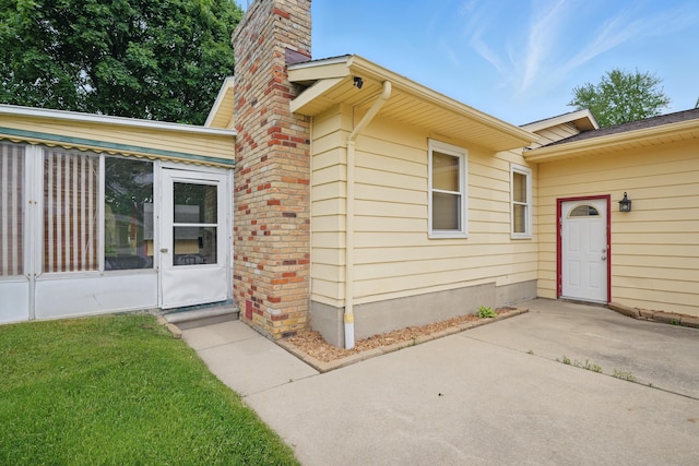 1451 Peachwood Dr, Flint, MI 48507 - entrance to property featuring a patio area, a chimney, and a lawn