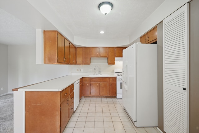 1451 Peachwood Dr, Flint, MI 48507 - kitchen with white appliances, a sink, brown cabinetry, light countertops, and under cabinet range hood