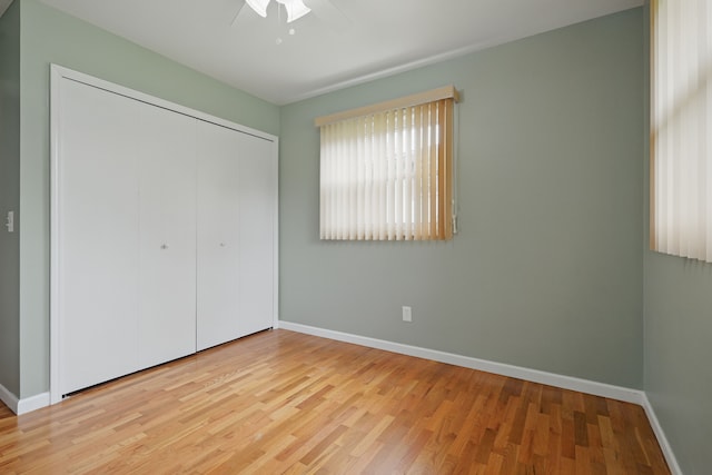 1451 Peachwood Dr, Flint, MI 48507 - unfurnished bedroom with baseboards, wood finished floors, a closet, and ceiling fan