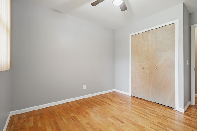 1451 Peachwood Dr, Flint, MI 48507 - unfurnished bedroom featuring light wood-style floors, baseboards, a closet, and a ceiling fan