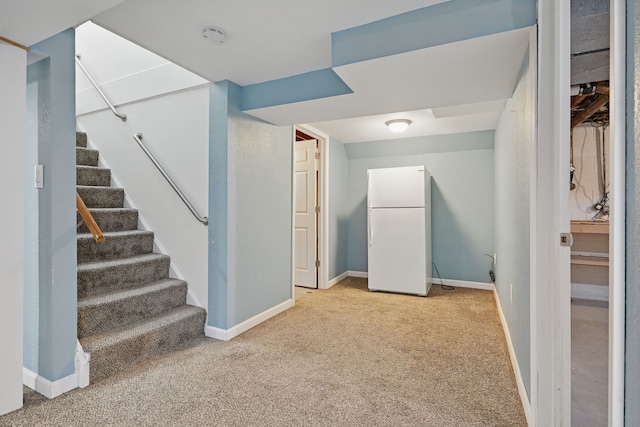 1451 Peachwood Dr, Flint, MI 48507 - below grade area with freestanding refrigerator, light carpet, stairs, and baseboards