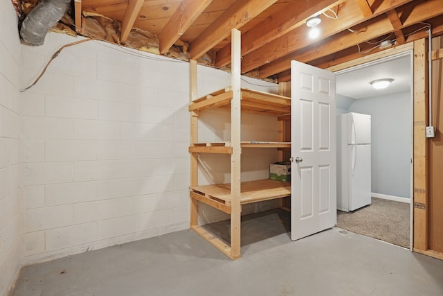 1451 Peachwood Dr, Flint, MI 48507 - unfinished below grade area with freestanding refrigerator