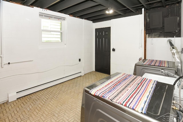 1466 Wilson Ave, Saginaw, MI 48638 - below grade area featuring a baseboard radiator, washer / clothes dryer, and electric panel