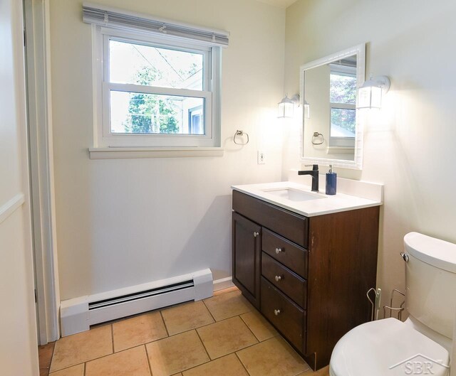 1466 Wilson Ave, Saginaw, MI 48638 - half bath with baseboard heating, toilet, vanity, and tile patterned flooring