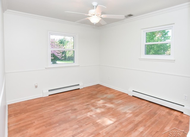 1466 Wilson Ave, Saginaw, MI 48638 - empty room with baseboard heating, crown molding, healthy amount of natural light, and light wood finished floors