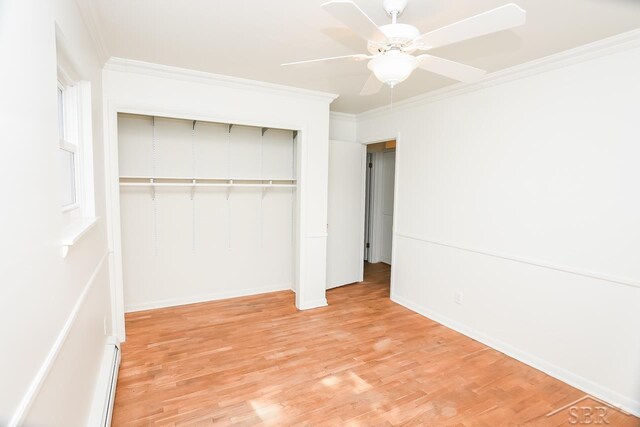 1466 Wilson Ave, Saginaw, MI 48638 - unfurnished bedroom featuring ornamental molding, a closet, light wood-style flooring, baseboards, and a ceiling fan