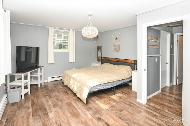 1466 Wilson Ave, Saginaw, MI 48638 - bedroom with a baseboard radiator and wood finished floors